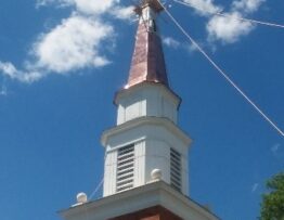 steeplejacks installing new copper and restored cross to steeple