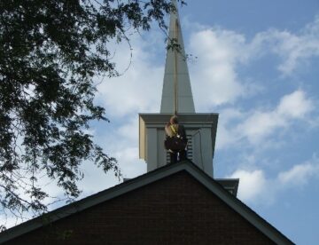 Steeplejacks painting and repairing church steeple