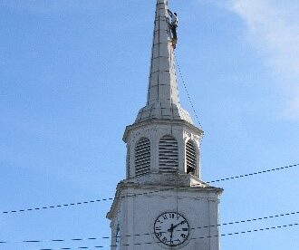 Steeplejacks painting church steeple
