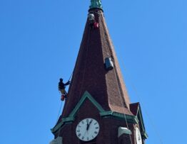 Steeplejacks installing new deck & roof on a church steeple